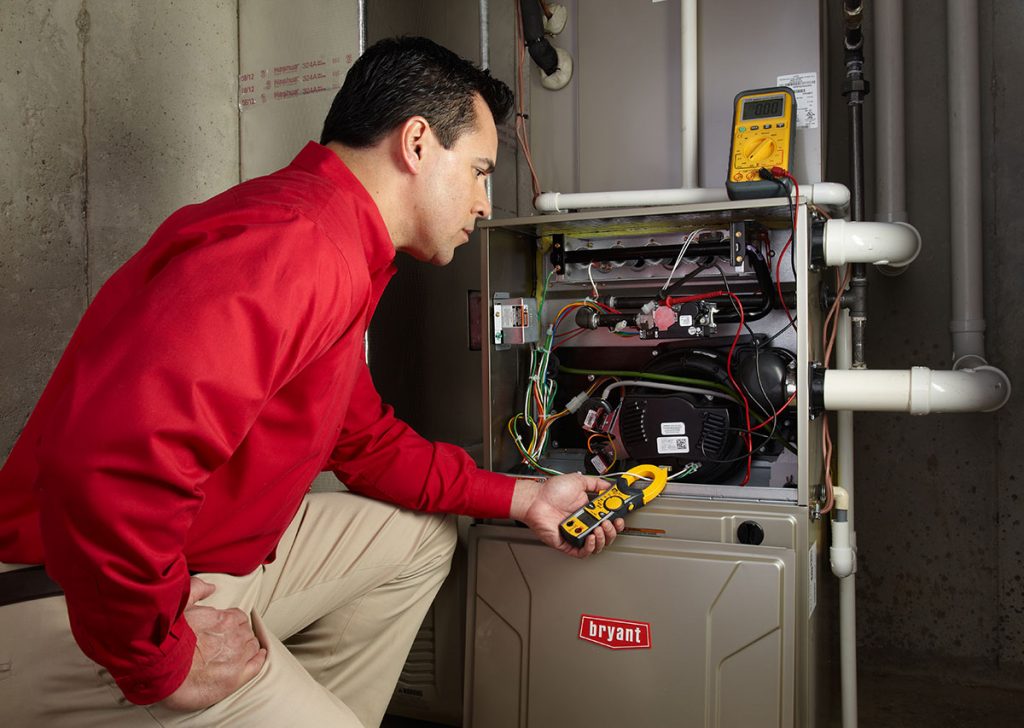 HVAC technician repairing an indoor furnace in Fountain