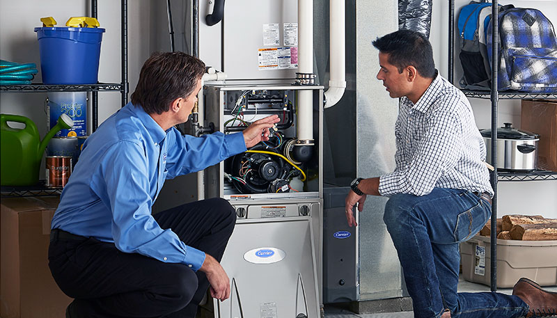 HVAC technician evaluating a furnace for repair or replacement in Fountain