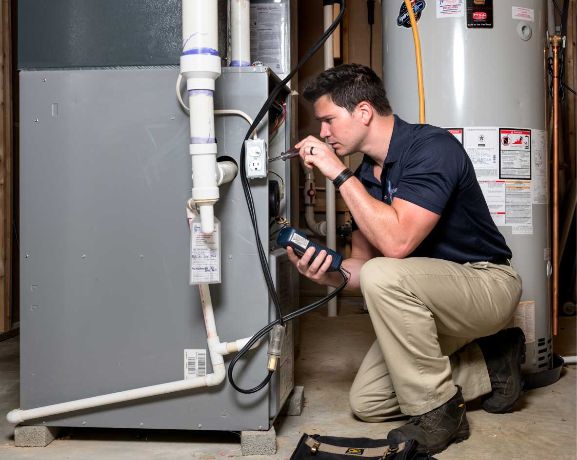 HVAC technician performing a furnace tune-up in Fountain
