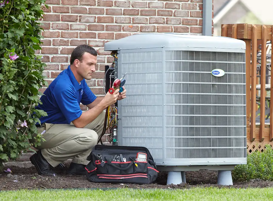 HVAC technician inspecting an outdoor air conditioning unit in Fountain