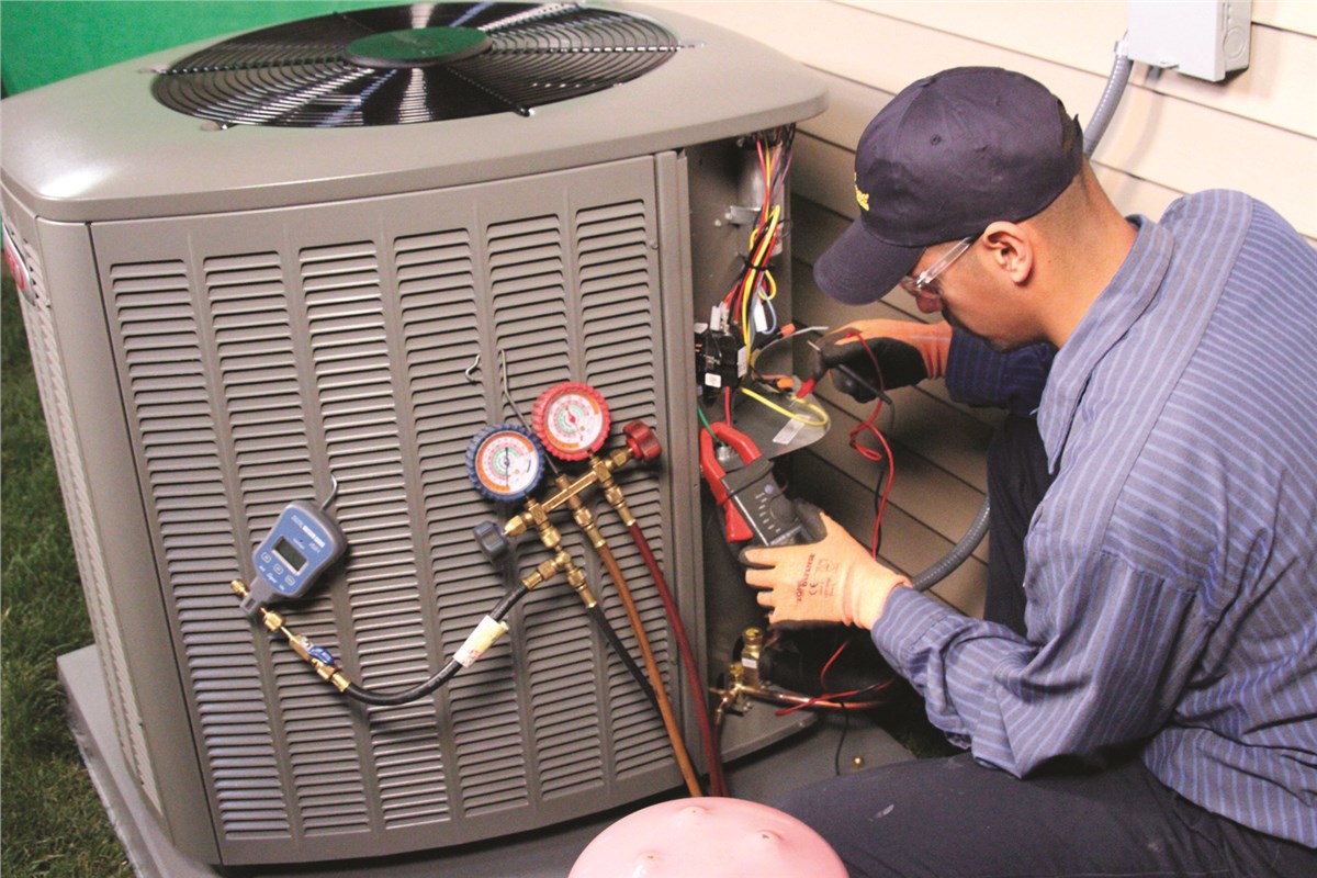 HVAC technician testing an outdoor air conditioning unit in Fountain